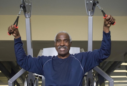 portrait-of-happy-senior-man-exercising-in-gym
